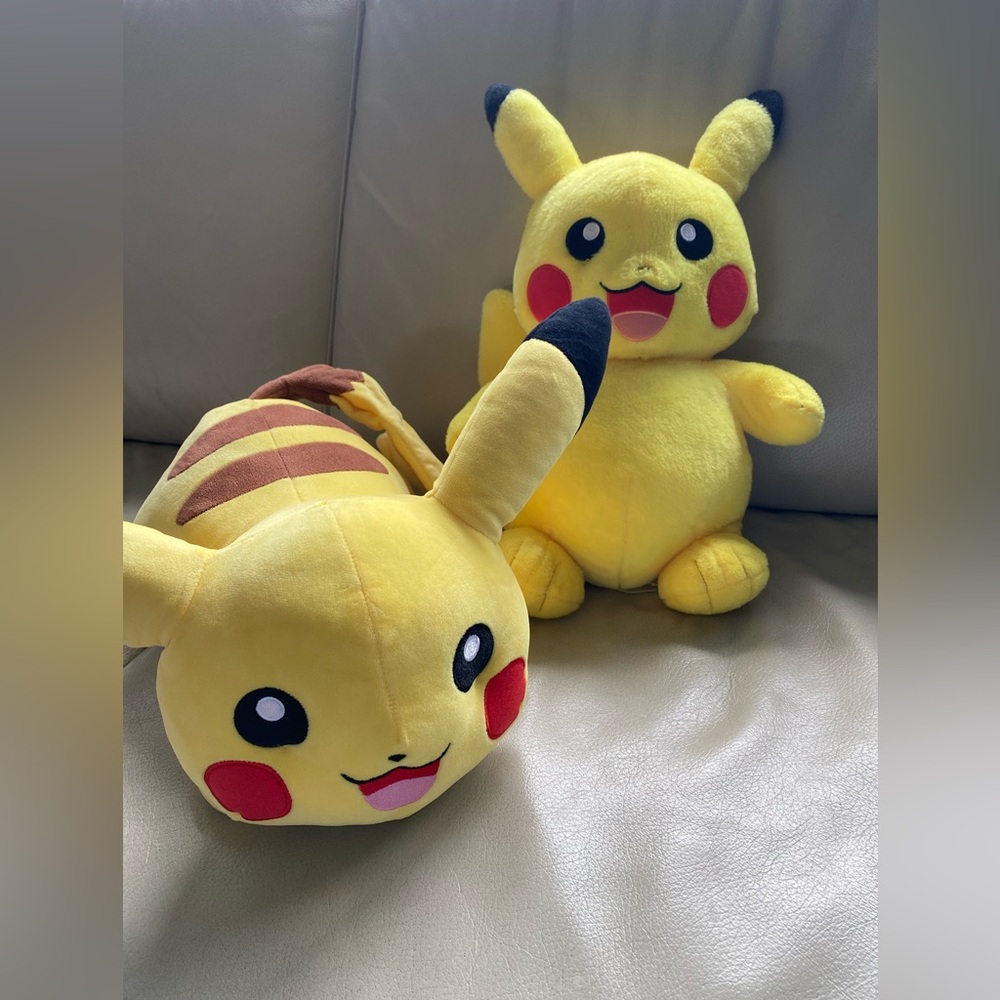 2 Pokemon, Center Pikachu Plush ~ 1 is build a bear.